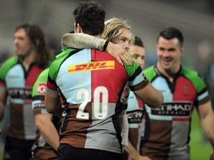 Harlequins' winger Tom Williams (C) celebrates with his teammate Harlequins' flanker Joe Trayfoot (C-back) at the end of the European Cup rugby union match between Racing Metro 92 and Harlequins on December 7, 2013