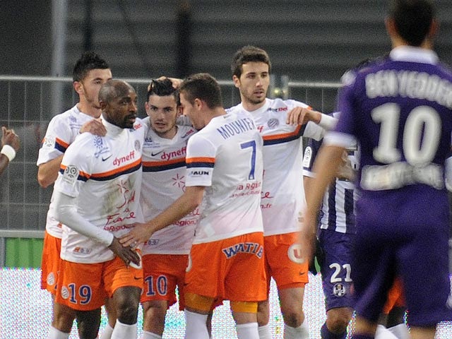 Montpellier's Remy Cabella celebrates with teammates after scoring the opening goal against Toulouse during their Ligue 1 match on December 8, 2013