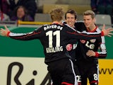 Bayer Leverkusen's Robbie Kruse is congratulated by teammates after scoring the opening goal against Freiburg during the 3rd round of the German Cup on December 4, 2013