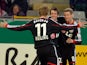 Bayer Leverkusen's Robbie Kruse is congratulated by teammates after scoring the opening goal against Freiburg during the 3rd round of the German Cup on December 4, 2013