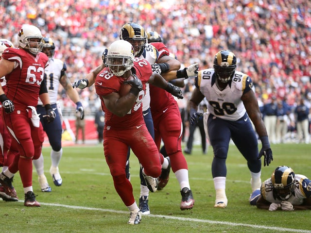 Running back Rashard Mendenhall #28 of the Arizona Cardinals scores on a 3 yard rushing touchdown against the St. Louis Rams during the first quarter of the NFL game at the University of Phoenix Stadium on December 8, 2013