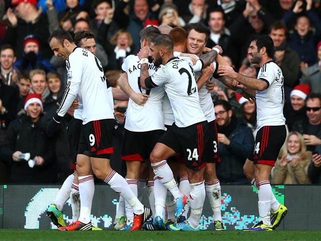 Fulham's Steve Sidwell celebrates with teammates after scoring the opening goal against Aston Villa during their Premier League match on December 8, 2013