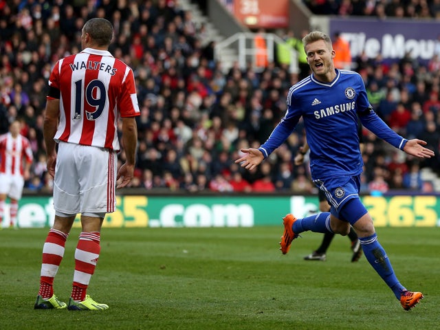 Andre Schurrle of Chelsea celebrates after scoring their first goal during the Barclays Premier League match between Stoke City and Chelsea at Britannia Stadium on December 7, 2013