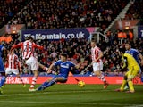 Peter Crouch of Stoke shoots past Gary Cahill of Chelsea to score a goal to level the scores at 1-1 during the Barclays Premier League match between Stoke City and Chelsea at Britannia Stadium on December 7, 2013
