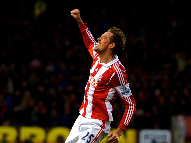 Peter Crouch of Stoke celebrates after scoring a goal to level the scores at 1-1 during the Barclays Premier League match between Stoke City and Chelsea at Britannia Stadium on December 7, 2013 