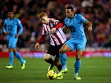 Jack Colback of Sunderland battles with Mousa Dembele of Tottenham during the Barclays Premier League match between Sunderland and Tottenham Hotspur at the Stadium of Light on December 7, 2013
