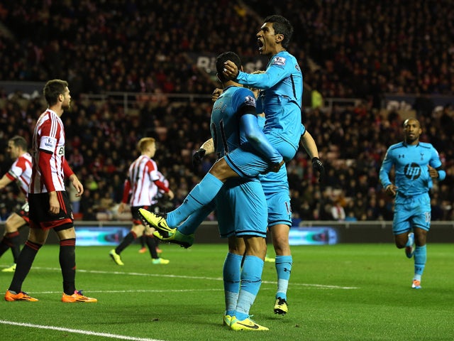 Paulinho of Tottenham celebrates his goal with team mate Nacer Chadli during the Barclays Premier League match between Sunderland and Tottenham Hotspur at the Stadium of Light on December 7, 2013