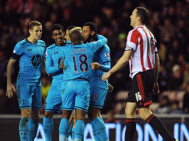 Moussa Dembele of Tottenham Hotspur celebrates with his team-mates after John O'Shea of Sunderland scored an own goal during the Barclays Premier League match between Sunderland and Tottenham Hotspur at Stadium of Light on December 07, 2013
