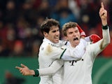 Bayern Munich's Thomas Muller celebrates with teammate Javi Martinez after scoring his team's second goal against Augsburg during their 3rd round German Cup match on December 4, 2013