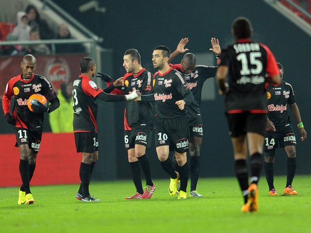 Guingamp's French forward Cedric Faure (C) celebrates after scoring a goal during the French L1 football match between Valenciennes and Guingamp at Stade Du Hainaut in Valenciennes on December 7, 2013