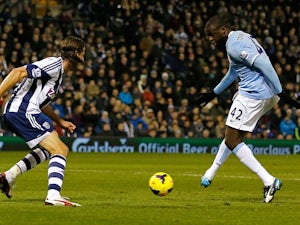 Man City's Yaya Toure scores his team's second goal against West Brom during their Premier League match on December 4, 2013