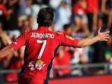 Jeronimo Neumann of Adelaide United celebrates after scoring their fourth goal during the round 10 A-League match between Adelaide United and the Central Coast Mariners at Coopers Stadium on December 14, 2013