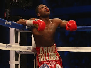 Adrien Broner rests in the corner against Marcos Maidana during their WBA Welterweight Title bout at Alamodome on December14, 2013