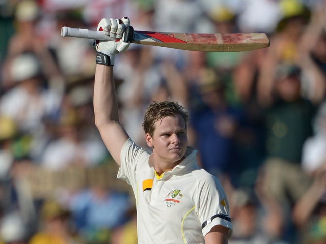 Australia's batsman Steven Smith raises his bat as he reaches his 100 on day one of the third Ashes cricket Test against England in Perth on December 13, 2013