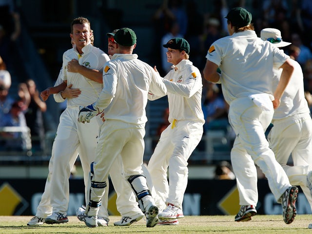 Peter Siddle of Australia is congratulated by team mates after taking the wicket of Kevin Pietersen of England during day two of the Third Ashes Test Match between Australia and England at WACA on December 14, 2013