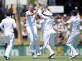 Stuart Broad of England celebrates with teammates after dismissing Mitchell Johnson of Australia during day two of the Third Ashes Test Match between Australia and England at WACA on December 14, 2013