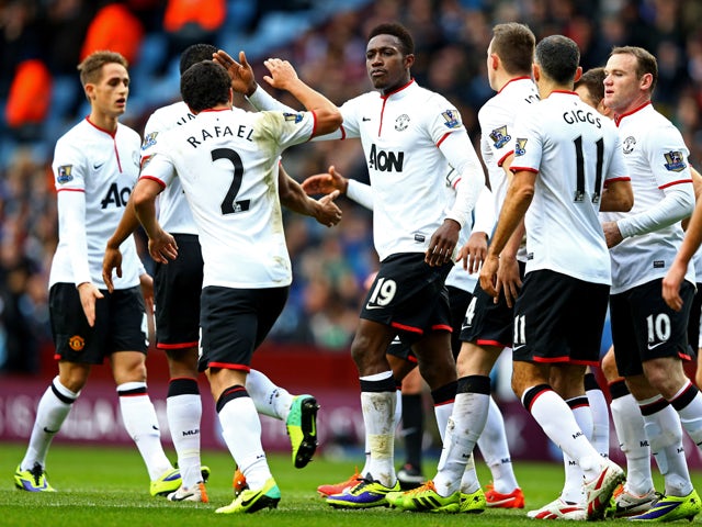 Danny Welbeck of Manchester United is by congratulated by Rafael da Silva and team mates as he scores their first goal during the Barclays Premier League match between Aston Villa and Manchester United at Villa Park on December 15, 2013