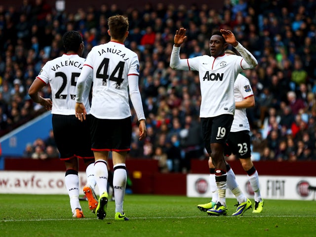 Danny Welbeck of Manchester United celebrates with team mates Luis Antonio Valencia and Adnan Januzaj as he scores their second goal during the Barclays Premier League match between Aston Villa and Manchester United at Villa Park on December 15, 2013