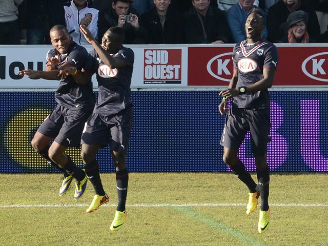 Bordeaux' Jussie Ferreira Vieira celebrates with teammates after scoring during the French L1 football match Bordeaux vs Valenciennes on December 15, 2013