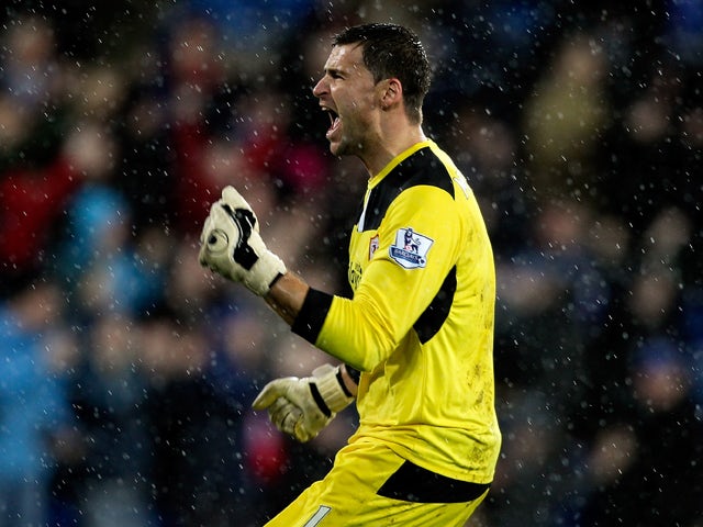 David Marshall of Cardiff celebrates after Peter Whittingham scores his team's opening goal of the game during the Premier League match between Cardiff City and West Bromwich Albion at Cardiff City Stadium on December 14, 2013