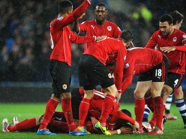 Peter Whittingham #7 of Cardiff City is congratulated by team-mates after scoring the opening goal during the Barclays Premier League match between Cardiff City and West Bromwich Albion at Cardiff City Stadium on December 14, 2013