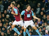 West Ham's Craig Bellamy celebrates with team mate Valon Behrami (L) after scoring the first goal of the match during their premiership match at home to Chelsea at Stamford Bridge football stadium on December 14, 2008