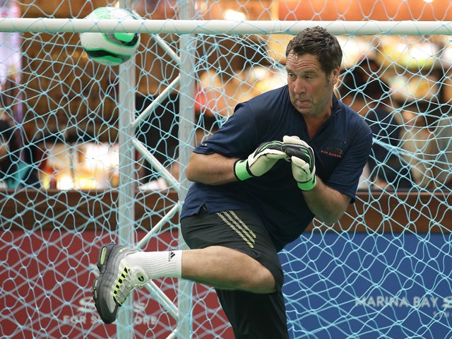 Former English football player, David Seaman reacts at goal in a football clinic with students from designated charities and local Singapore schools during the Sands for Singapore event at the Skating Rink at The Shoppes Marina Bay Sands on June 20, 2013