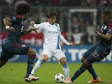Manchester City's Spanish midfielder David Silva vies with Bayern Munich's defender Jerome Boateng (R) and Bayern Munich's Brazilian defender Dante during the UEFA Champions League Group D on December 10, 2013
