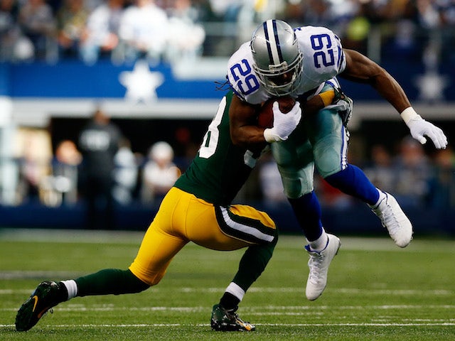Running back DeMarco Murray of the Dallas Cowboys is tackled by cornerback Tramon Williams #38 of the Green Bay Packers during a game at AT&T Stadium on December 15, 2013