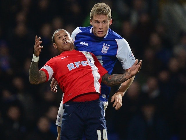 Blackburn Rovers striker DJ Campbell and Ipswich Town defender Christophe Berra tussle for the ball at Portman Road during a Championship match on December 3, 2013