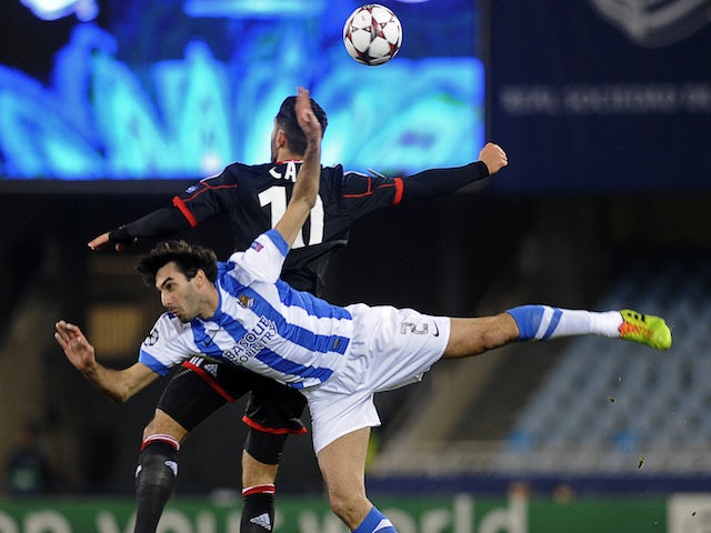 Leverkusen's midfielder Emre Can (L) vies with Real Sociedad's defender Carlos Martinez during the UEFA Champions League Group A football match Real Sociedad de Futbol vs Bayer 04 Leverkusen on December 10, 2013