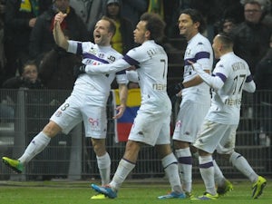 Toulouse's French midfielder Etienne Didot celebrates with teammates after scoring a goal during the French L1 football match between Nantes and Toulouse on December 14, 2013