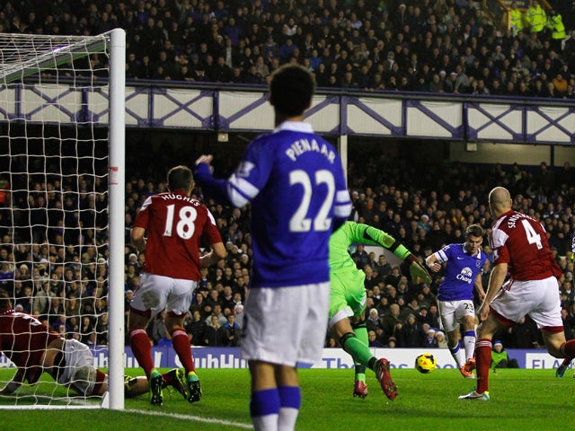 Seamus Coleman of Everton scores his team's second goal during the Barclays Premier League match between Everton and Fulham at Goodison Park on December 14, 2013