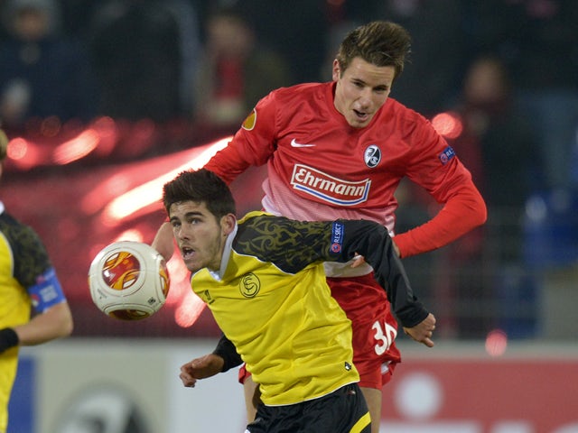 Freiburg's defender Christian Guenter and Sevilla's midfielder Jairo Samperio vie for the ball during the UEFA Europa League group H football match SC Freiburg vs Sevilla FC in Freiburg, southern Germany on December 12, 2013