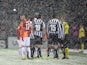 Galatasaray's and Juventus' players speak with referee Pedro Proenca after a heavy snow fall halted their UEFA Champions League group B football match at the TT Arena Stadium on December 10, 2013