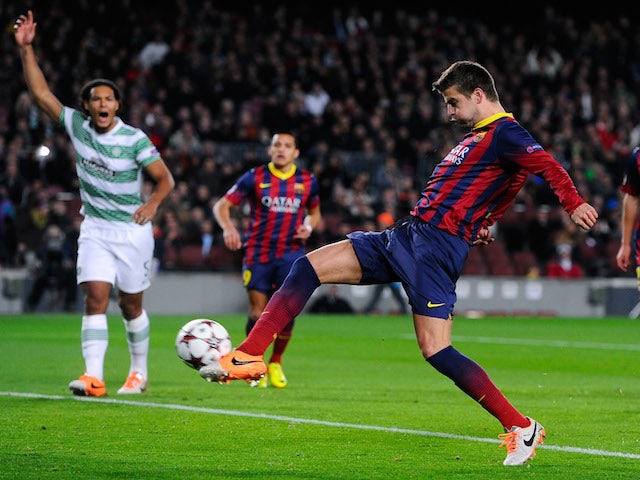 Gerard Pique of FC Barcelona scores the opening goal during the UEFA Champions League Group H match between FC Barcelona and Celtic FC at Camp Nou on December 11, 2013