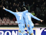 SSC Napoli's forward Gonzalo Higuain celebrates with his teammate Jose Maria Callejon after scoring during the Italian Serie A football match between SSC Napoli and Inter Milan on December 15, 2013