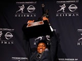 Jameis Winston, quarterback of the Florida State Seminoles, hoist the trophy during a press conference after the 2013 Heisman Trophy Presentation at the Marriott Marquis on December 14, 2013