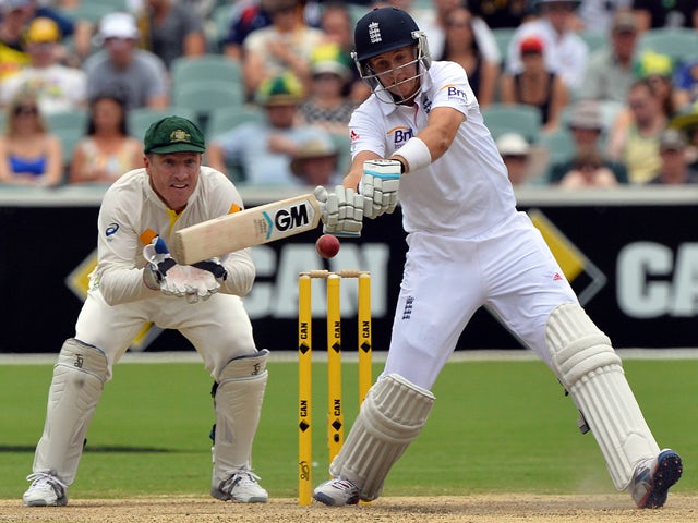 England's Joe Root plays a shot for a boundary as Australia's wicketkeeper Brad Haddin look on during the day four of the second Ashes cricket Test match against Australia in Adelaide on December 8, 2013