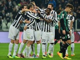 Juventus' players celebrate after scoring a goal during the Serie A football match between Juventus and Sassuolo at the Juventus Stadium in Turin on December 15, 2013