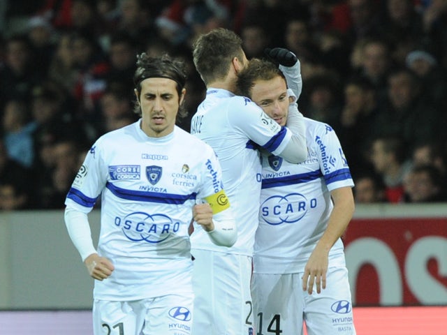 Bastia's French midfielder Ludovic Genest is congratulated by teammates after scoring during the French L1 football match Lille vs Bastia on December 15, 2013