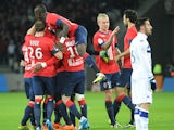 Lille's Ivorian forward Salomon Kalou is congratulated by teammates after scoring during the French L1 football match Lille vs Bastia on December 15, 2013