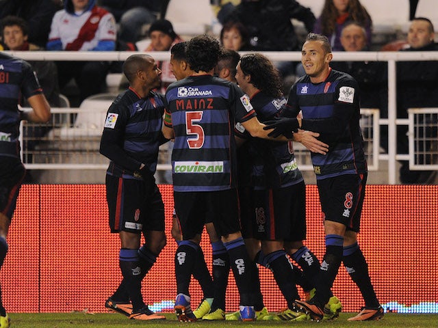 Mainz Garcia of Granada CF celebrates with Hassan Yebda (R) and team-mates after scoring the opening goal during the La Liga match against Rayo Vallecano de Madrid on December 14, 2013