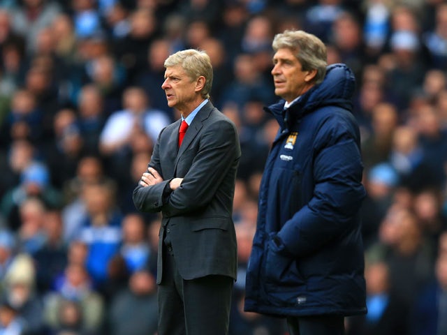 Arsene Wenger manager of Arsenal and Manuel Pellegrini manager of Manchester City look on during the Barclays Premier League match between Manchester City and Arsenal at Etihad Stadium on December 14, 2013