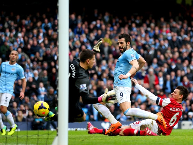 Laurent Koscielny of Arsenal fails to stop Alvaro Negredo of Manchester City scoring their second goal during the Barclays Premier League match between Manchester City and Arsenal at Etihad Stadium on December 14, 2013