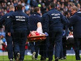 Laurent Koscielny of Arsenal is stretchered off during the Barclays Premier League match between Manchester City and Arsenal at Etihad Stadium on December 14, 2013