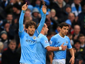 David Silva of Manchester City celebrates scoring their fourth goal during the Barclays Premier League match between Manchester City and Arsenal at Etihad Stadium on December 14, 2013