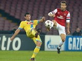 Arsenal's French midfielder Mathieu Flamini vies with Napoli's Swiss midfielder Blerim Dzemaili (L) during the UEFA Champions League group F football match on December 11, 2013