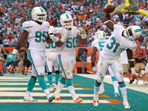 Michael Thomas of the Miami Dolphins celebrates a game clinching interception during a game against the New England Patriots at Sun Life Stadium on December 15, 2013
