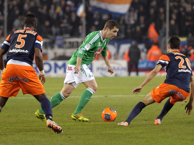 Saint-Etienne's French defender Francois Clerc vies for the ball with Montpellier's French mifielder Morgan Sanson and Montpellier's Ivoirian defender Siaka Tiene during the French L1 football match Montpellier vs Saint Etienne on December 13, 2013